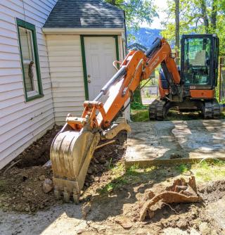Excavator digging near home